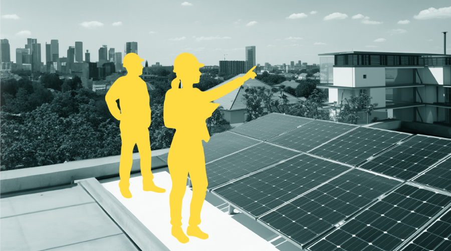 Two engineer silhouettes on a city building rooftop with photovoltaic panels.